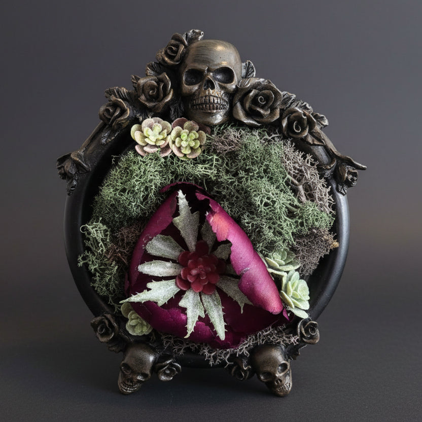 Decorative piece with skull, roses, and succulents on a textured surface