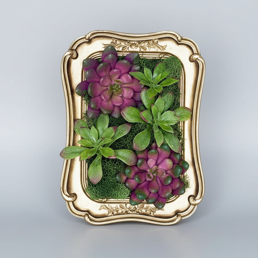 Decorative wall art with green and purple plants in a gold frame on a white background
