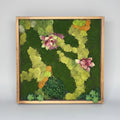 Framed moss wall art with pink flowers on a textured wall background