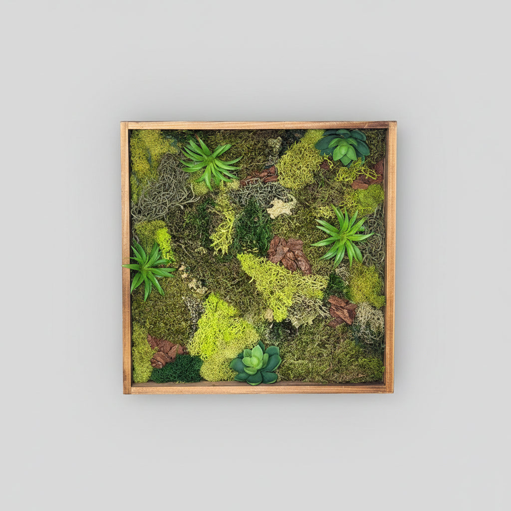 Framed wall art with green plants and moss on a white background