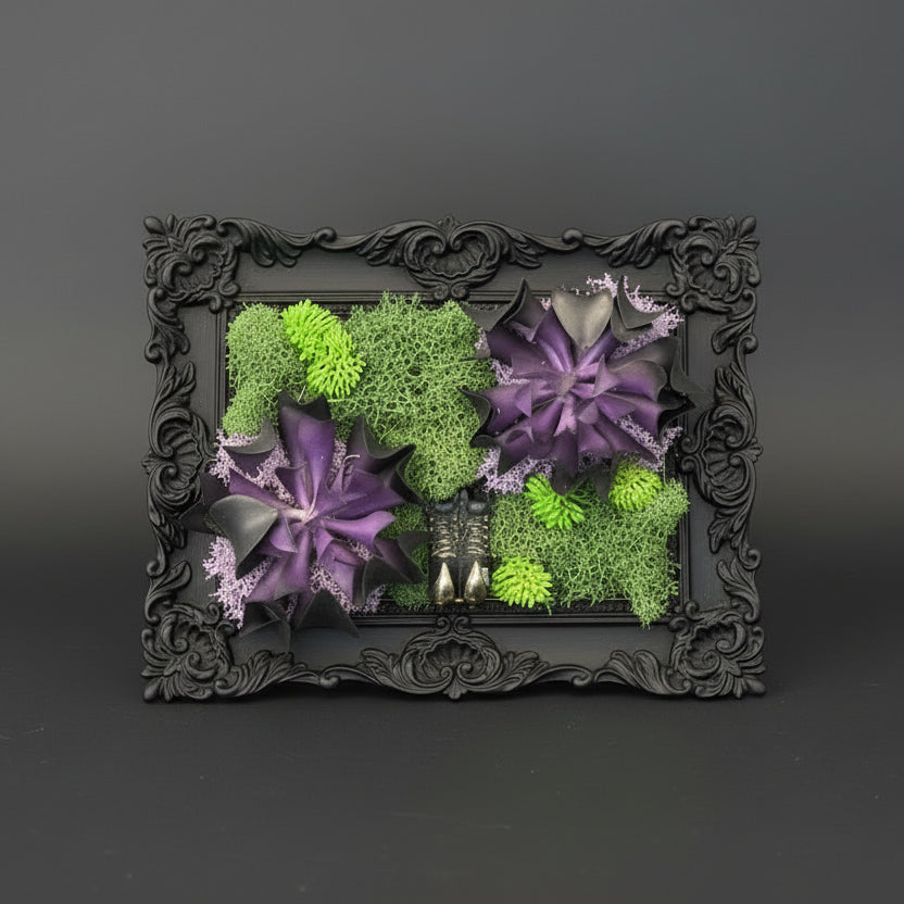Decorative frame with green and purple artificial flowers on a dark background